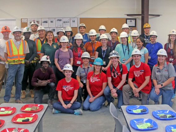 Group photo with everyone wearing hard hats